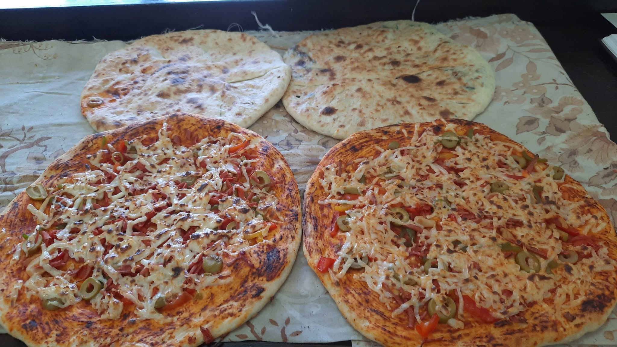 Fresh pizza-style pastries and za'atar manakish.