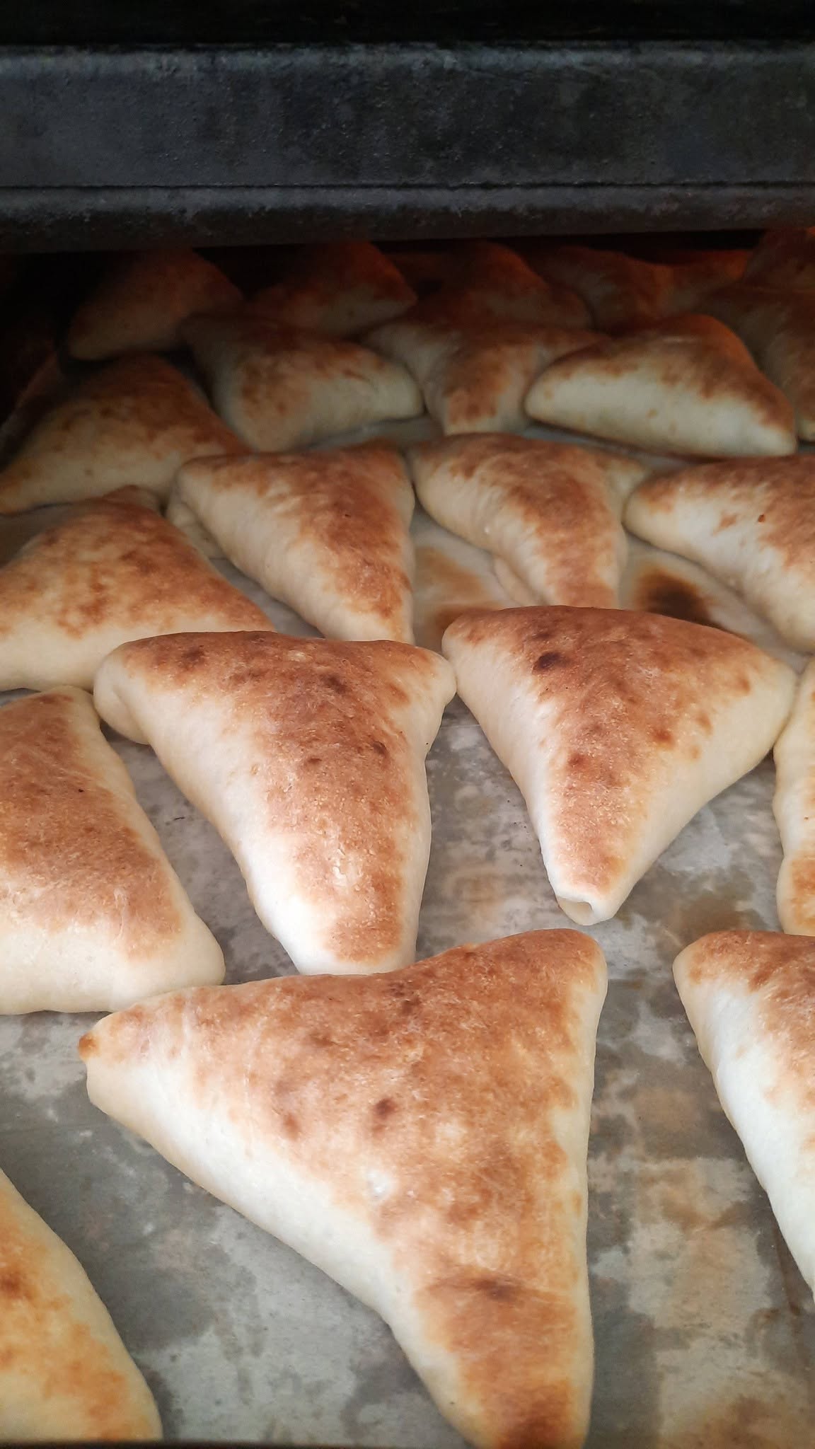 Cheese and za'atar sfiha pastries fresh from the oven.