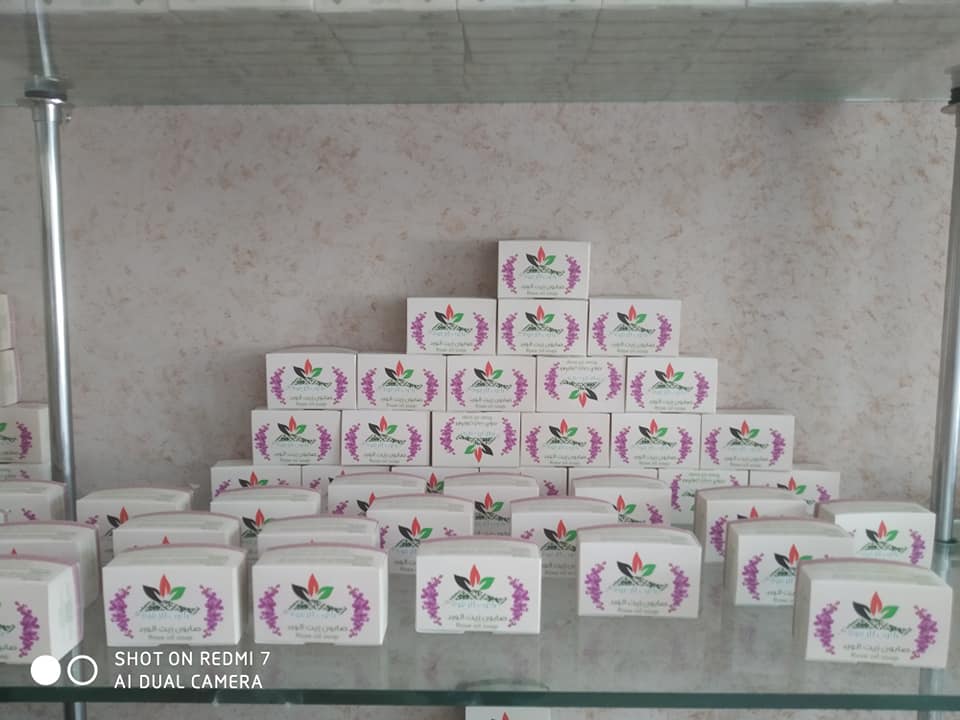 Boxes of handmade olive-oil soap stacked on a shop shelf.